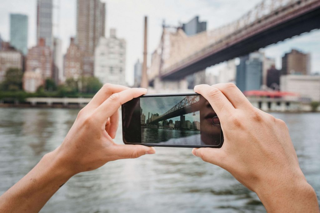 person-photographing-city-with-smartphone